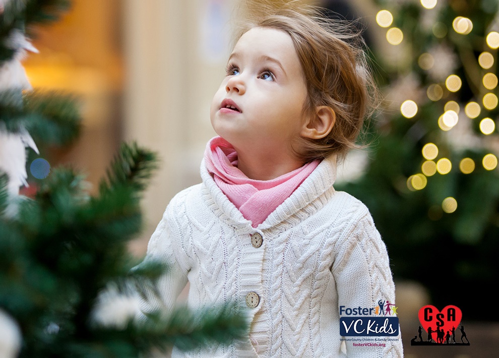 girl by Christmas tree