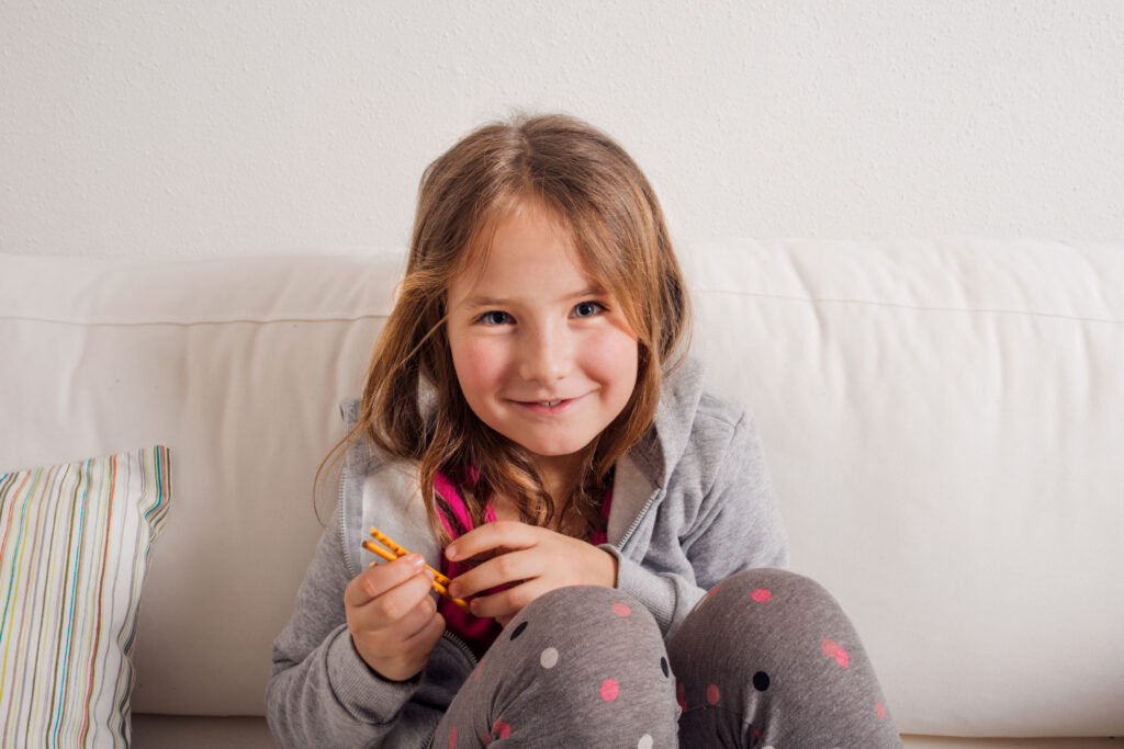 Girl at home sitting on sofa