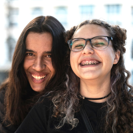 two teens smiling