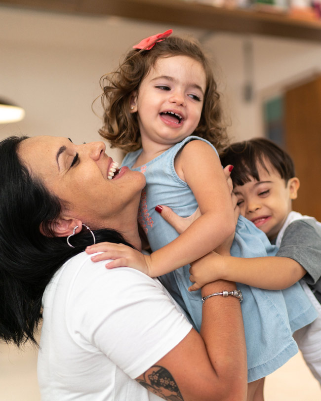 woman and two kids hugging